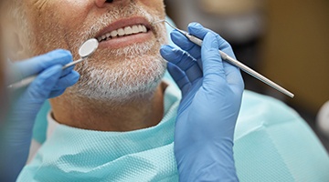 a dentist examining a patient’s mouth