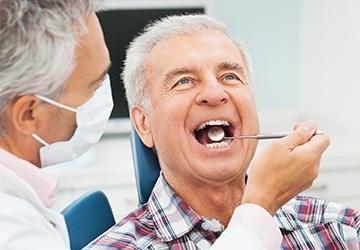 Senior man receiving dental exam