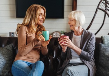 a woman with dentures conversing with a friend