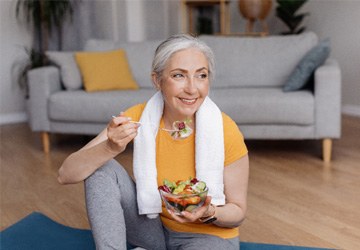 a woman with dentures eating a healthy meal