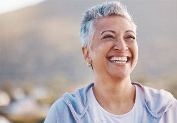 a woman smiling with dentures in Melbourne