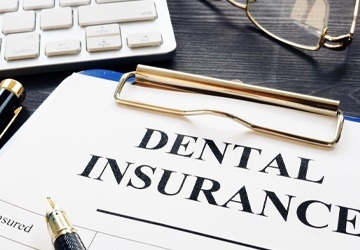 dental insurance forms on clipboard
