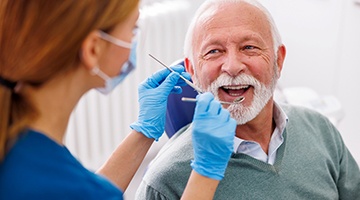 Man smiles at dentist