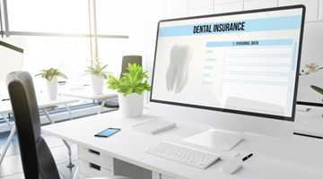 Dental insurance form on desktop in office