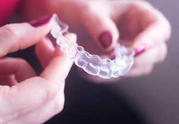 Close-up of woman holding Invisalign in Melbourne, FL
