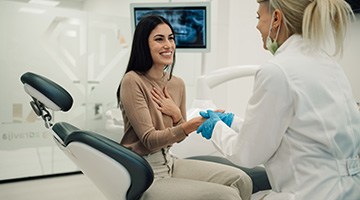 Smiling patient shaking dentist's hand