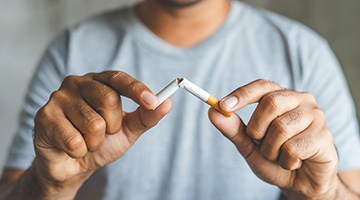 Closeup of patient breaking cigarette