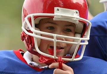 Young boy placing sportsguard