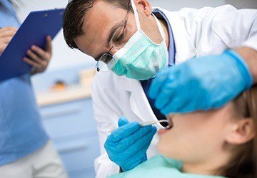 Dentist treating female patient