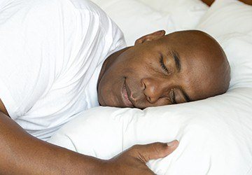 Man sleeping soundly in bed