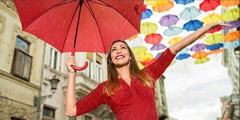 Woman standing under umbrella