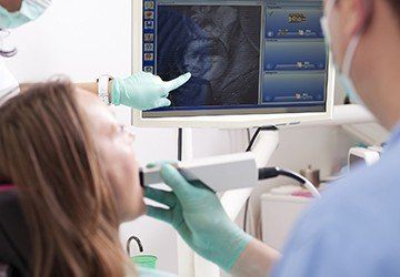 Dentist and patient looking at intraoral photos