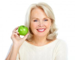 woman holding apple