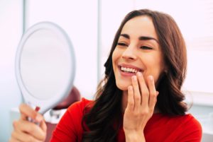 Woman admiring her dental implants