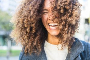 Woman smiling with tooth-colored fillings