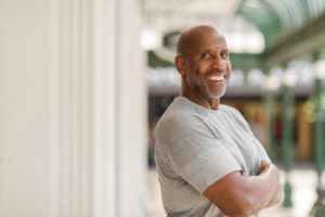 Man smiles confidently with dental implants in Melbourne