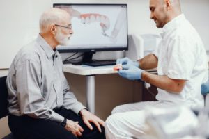 Dentist explaining why dental checkups with dentures matter.