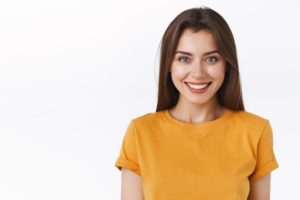 a patient smiling after receiving cosmetic dental work