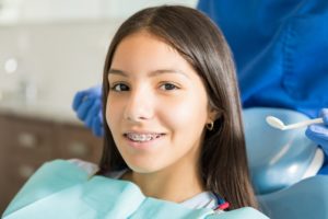 Young person with braces smiling