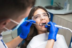 Woman with brown hair in dental chair having a root canal done